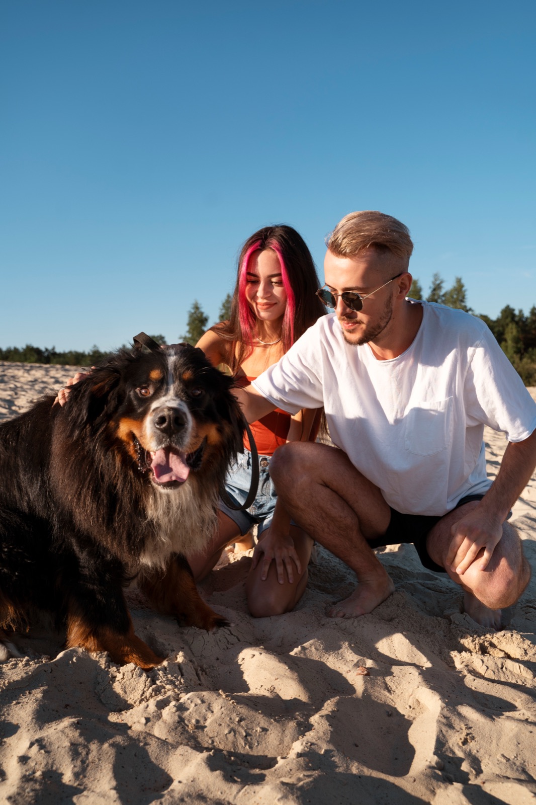 Two people with a dog enjoying an outdoor walk